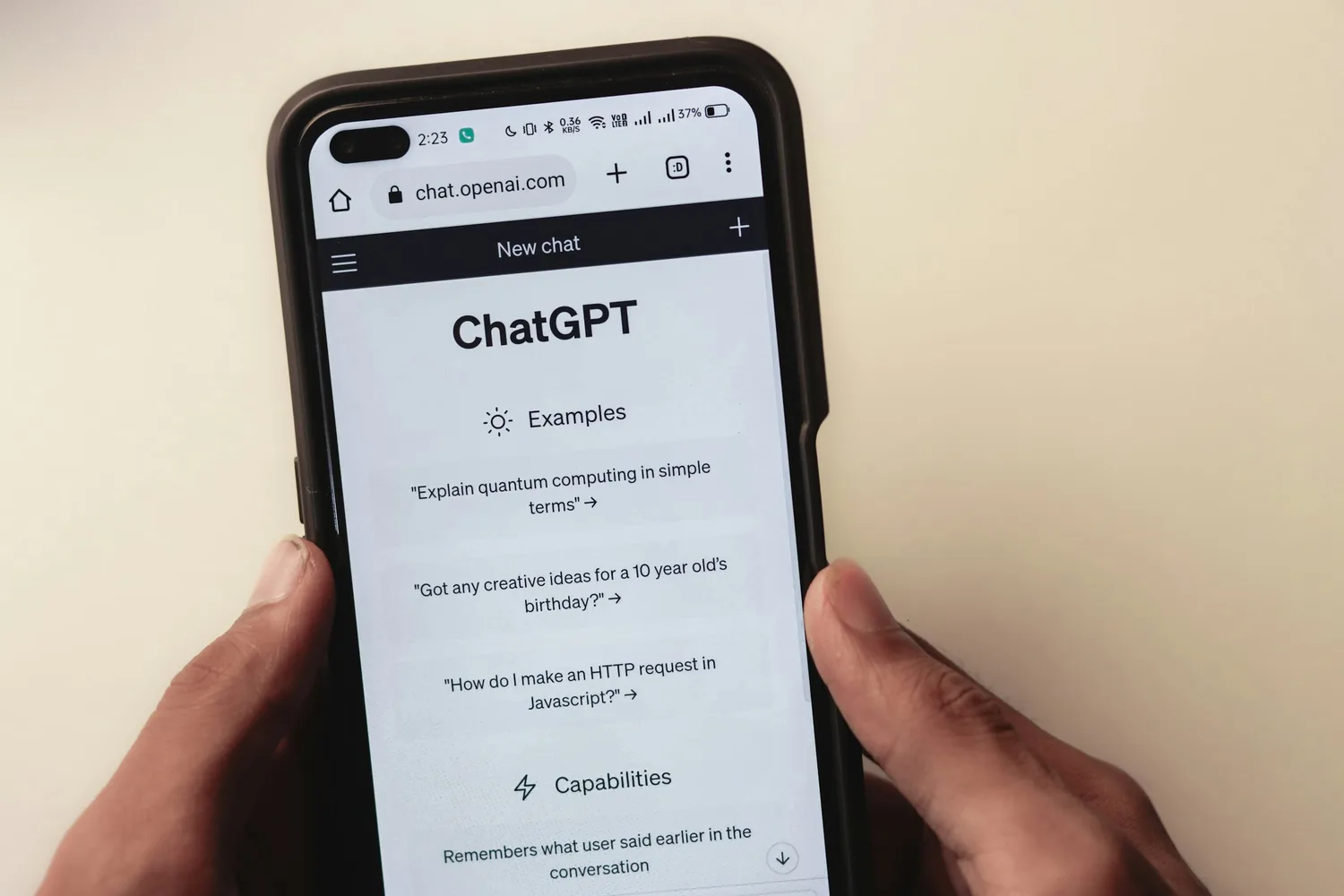 A customer holding a phone and using an AI chat assistant to search for and compare products, illustrating how discovery now runs partly through an outside AI agent instead of a browser tab full of manual comparisons.