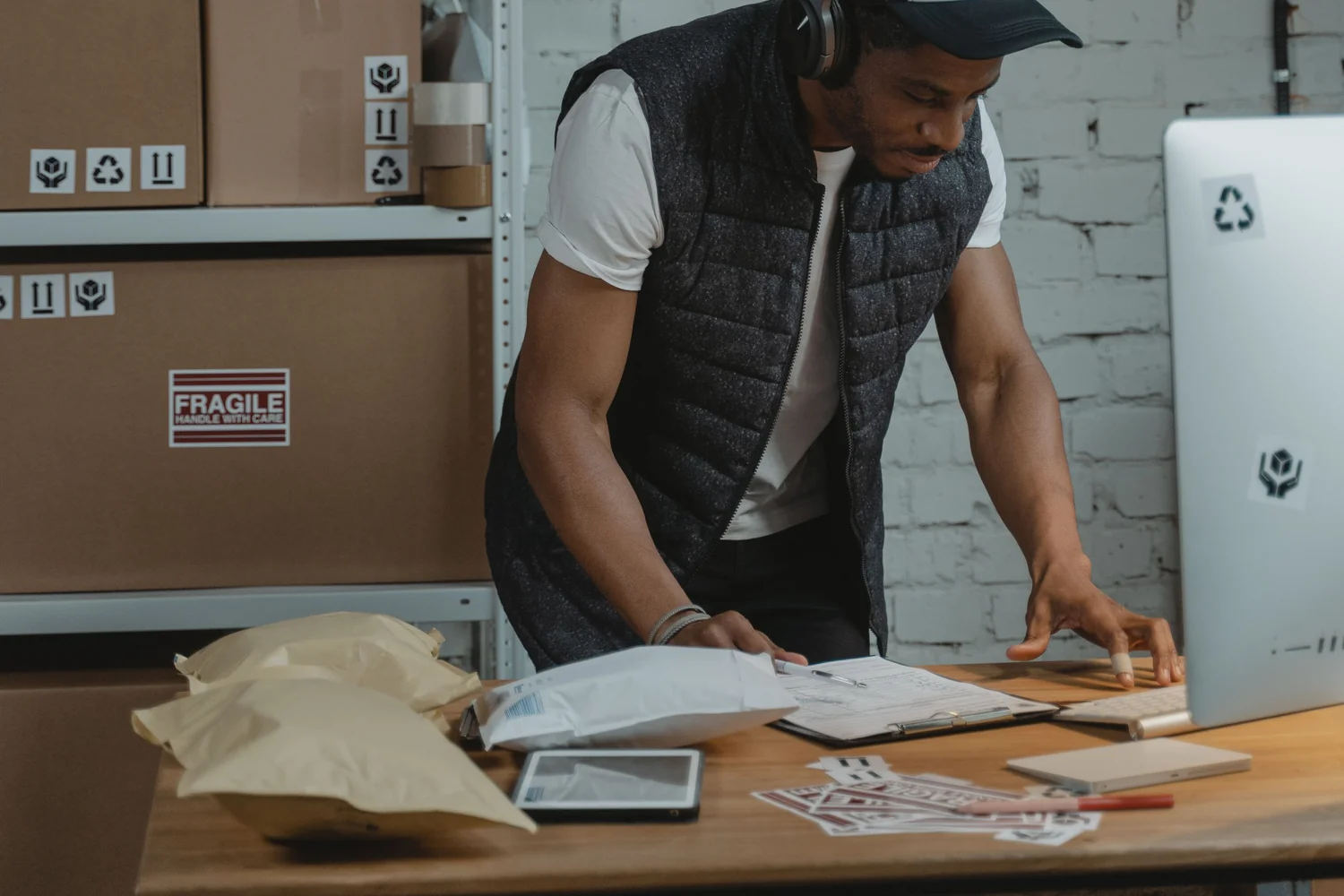 A support team member working through a backlog of return cases at a cluttered desk, the kind of stretched, under-time-pressure moment that pushes fraud triage toward either rejecting everything or accepting everything