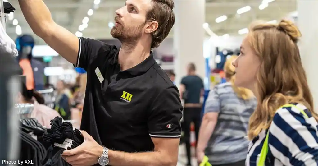 retail staff helping customer in store